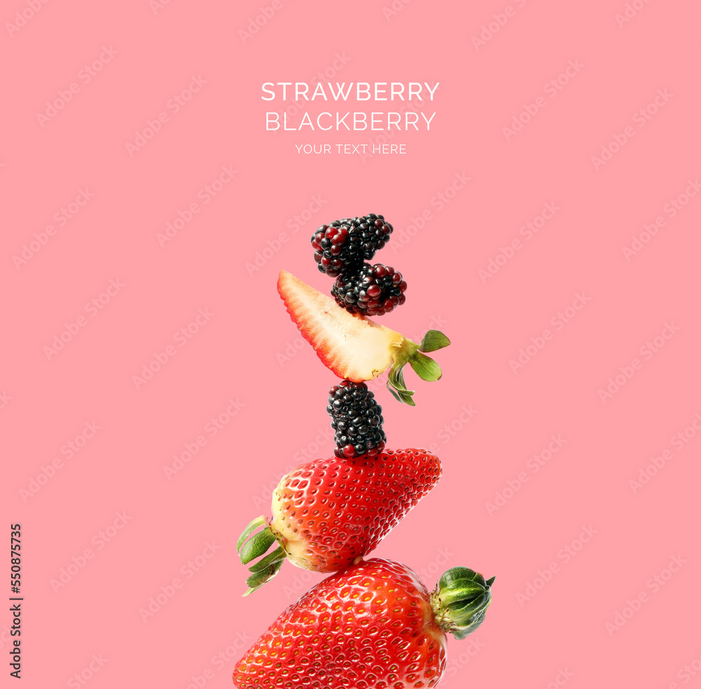 Creative layout made of strawberry and blackberry on the pink background. Flat lay. Food concept.  