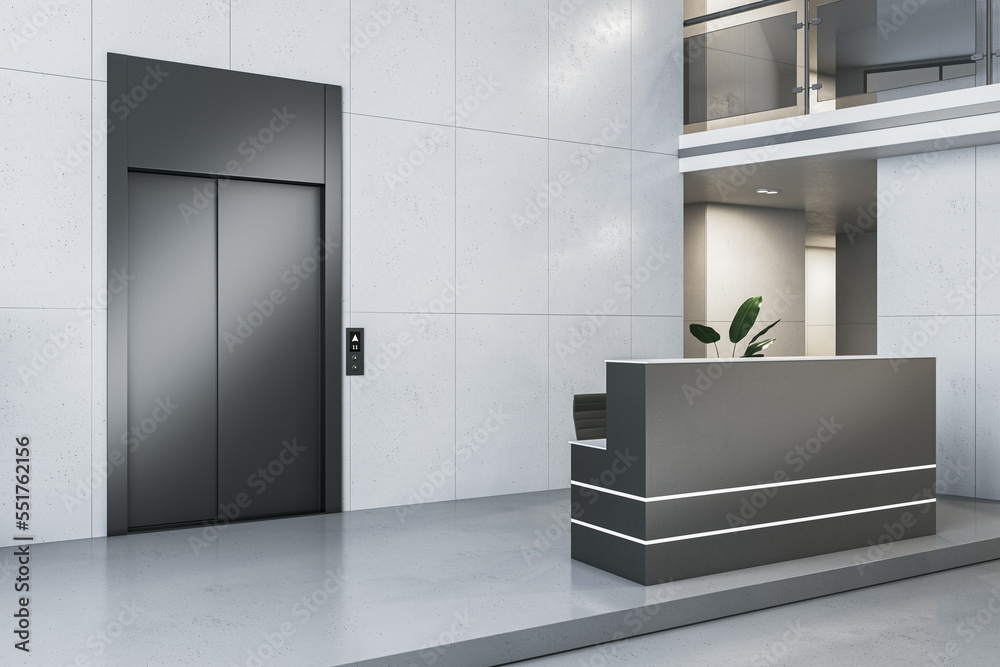 Clean office lobby interior with elevator and reception desk, docorative plant and concrete flooring