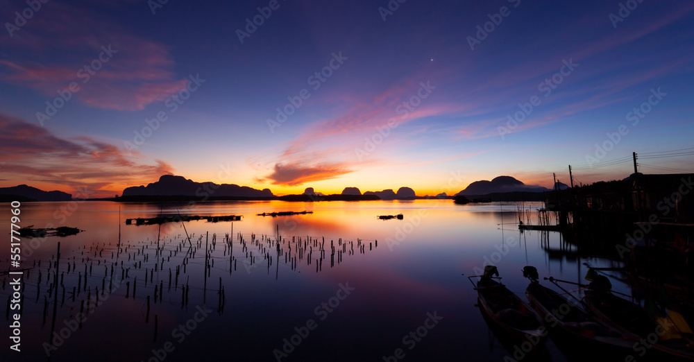 Landscape Long exposure of majestic clouds in the sky sunset or sunrise over sea with reflection in 