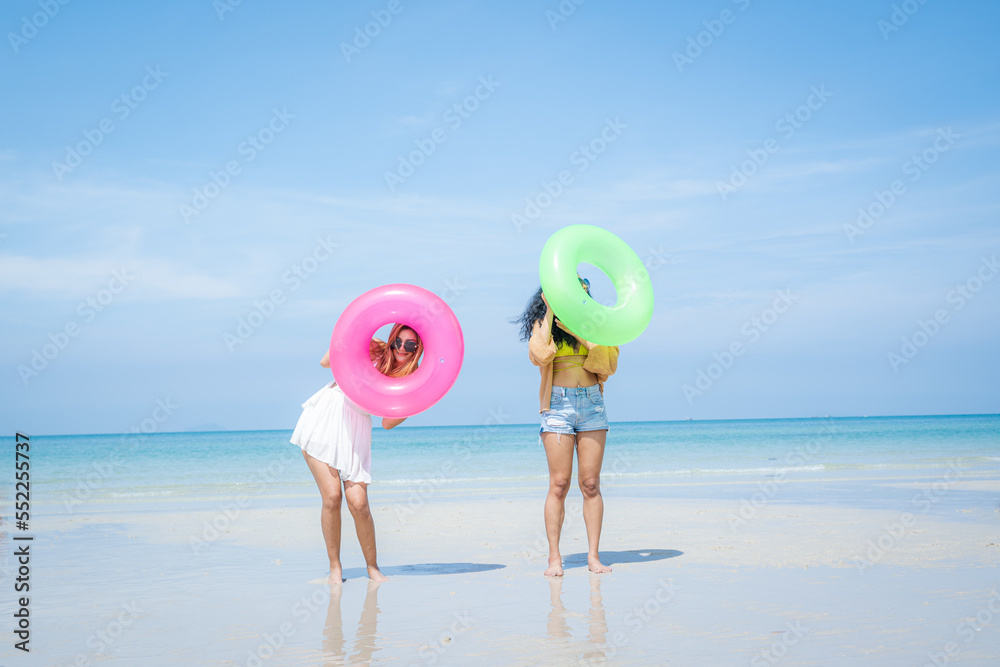 People spending time at the beautiful beach,Happy female friends enjoy activity on holiday travel va