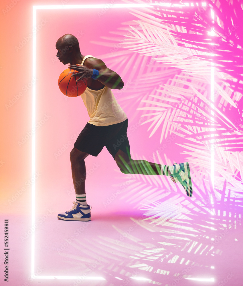 非裔美国篮球运动员运球和在长方形和植物旁跑动的侧视图
