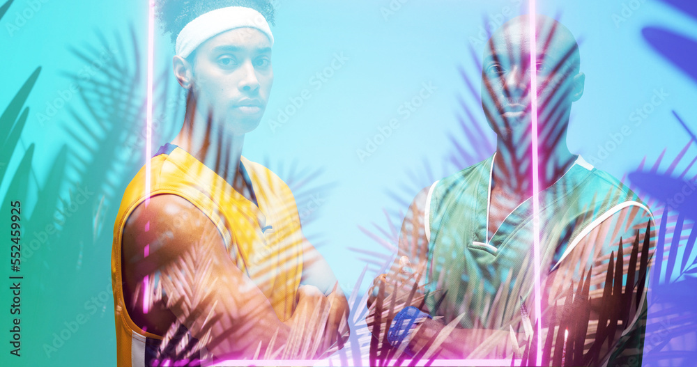 Portrait of african american basketball players with arms crossed standing by square and plants