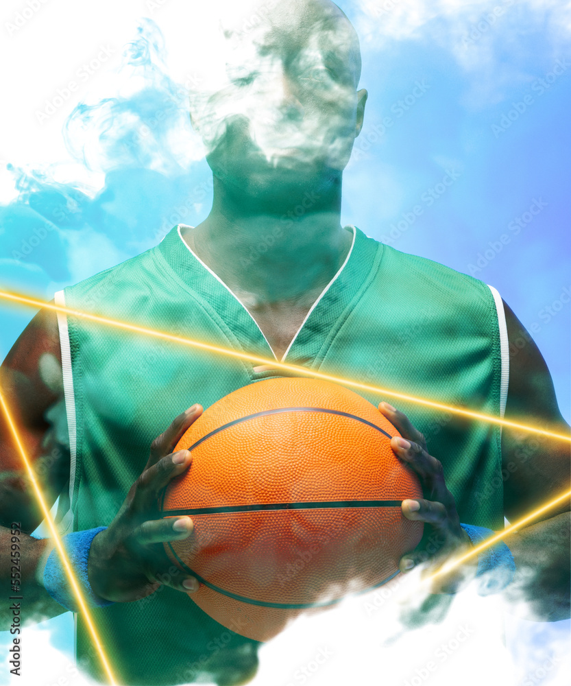非裔美国篮球运动员在烟熏背景下用照亮的三角形持球