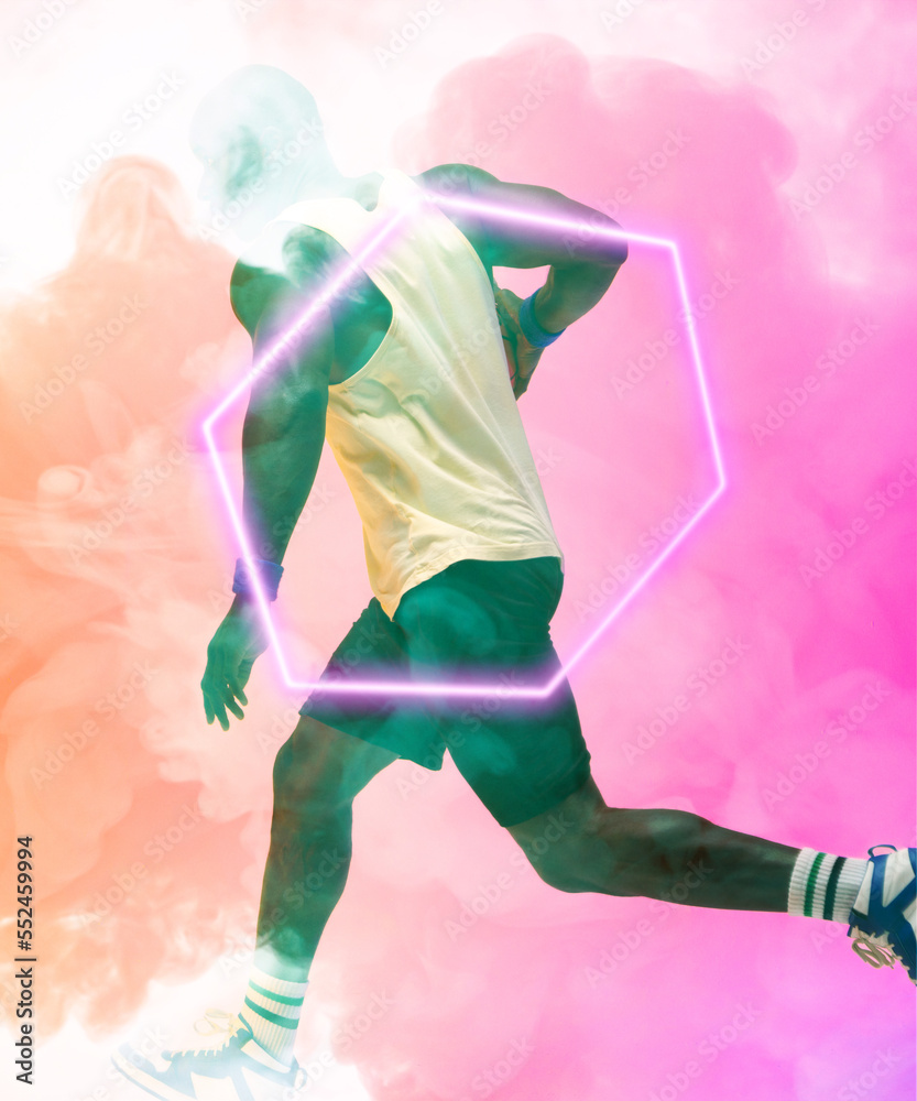 Side view of african american basketball player running by illuminated hexagon on smoky background