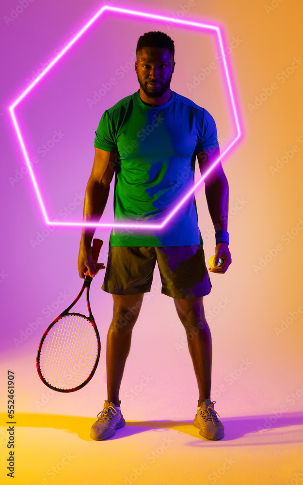 Hexagon neon over confident young african american tennis player with racket over colored background