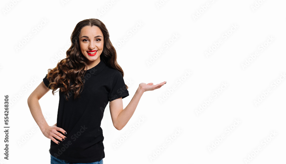Beautiful girl presenting. Smiling woman showing open hand palm with copy space for product or text.
