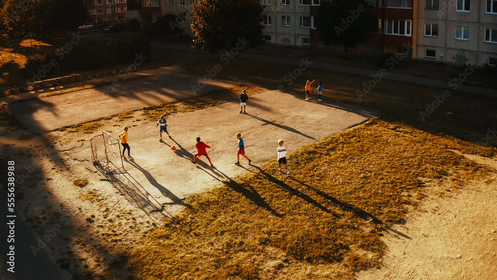 Aerial Drone Taking Off Shot of Neighborhood Friends Playing Soccer Outside in Urban Backyard. Multi