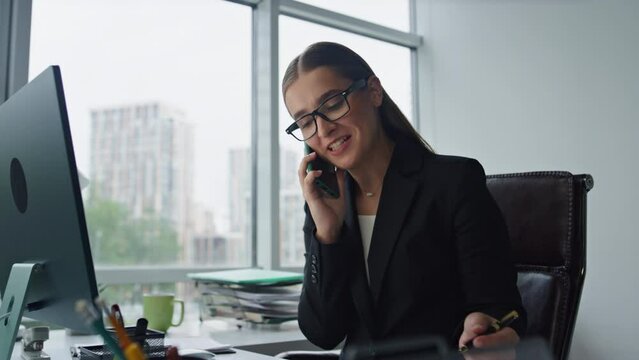 Sales agent talking phone consulting client closeup. Smiling woman work office