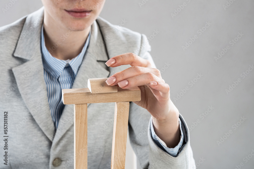 Business woman building tower on table