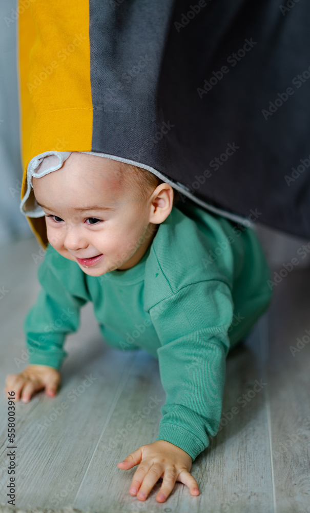 Curious baby boy studying nursery room. Handsome toddler portrait.