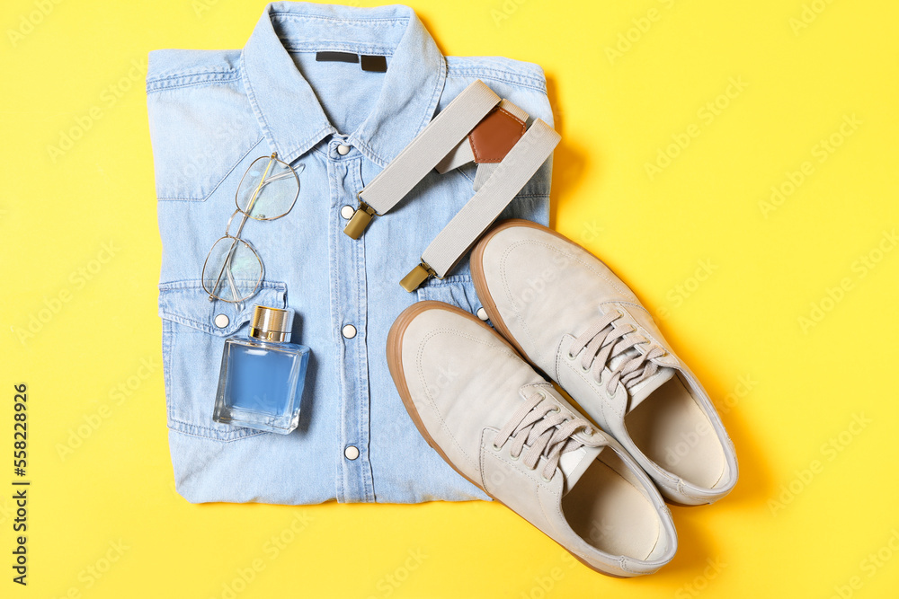 Denim shirt, male accessories and shoes on yellow background