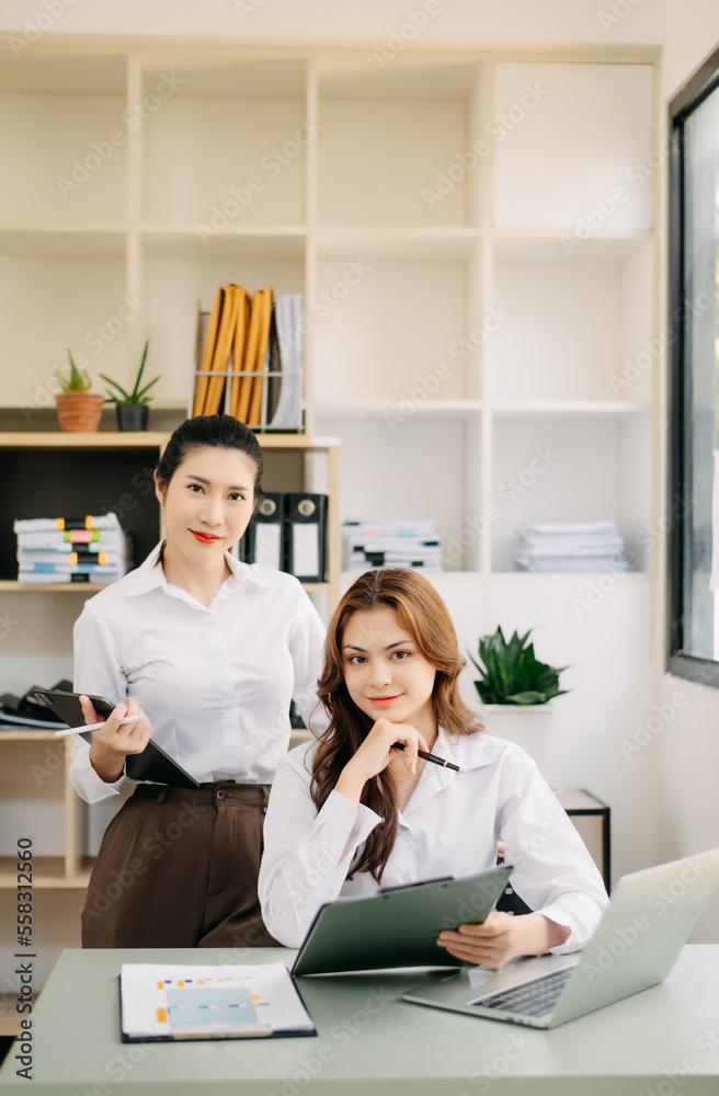 Young attractive two female office worker business suits smiling at camera