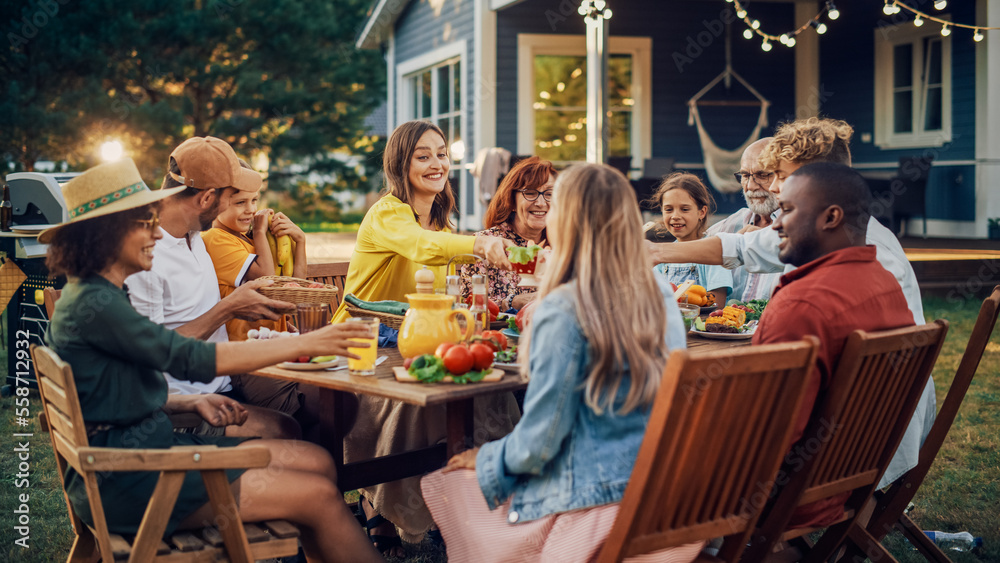 Family and Multiethnic Diverse Friends Gathering Together at a Garden Table. People Eating Grilled a