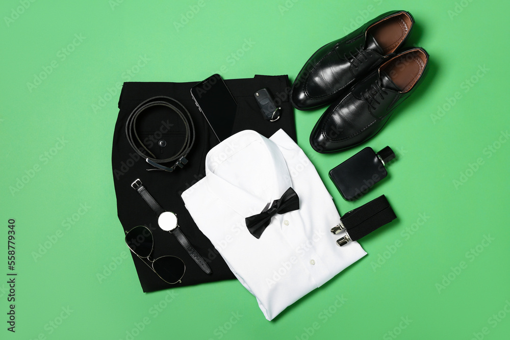 Elegant male clothes, accessories, car key and mobile phone on green background
