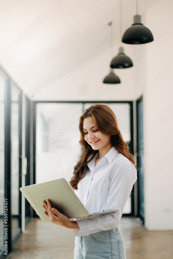  Working woman concept a female manager attending video conference and holding tablet, smatrphone an