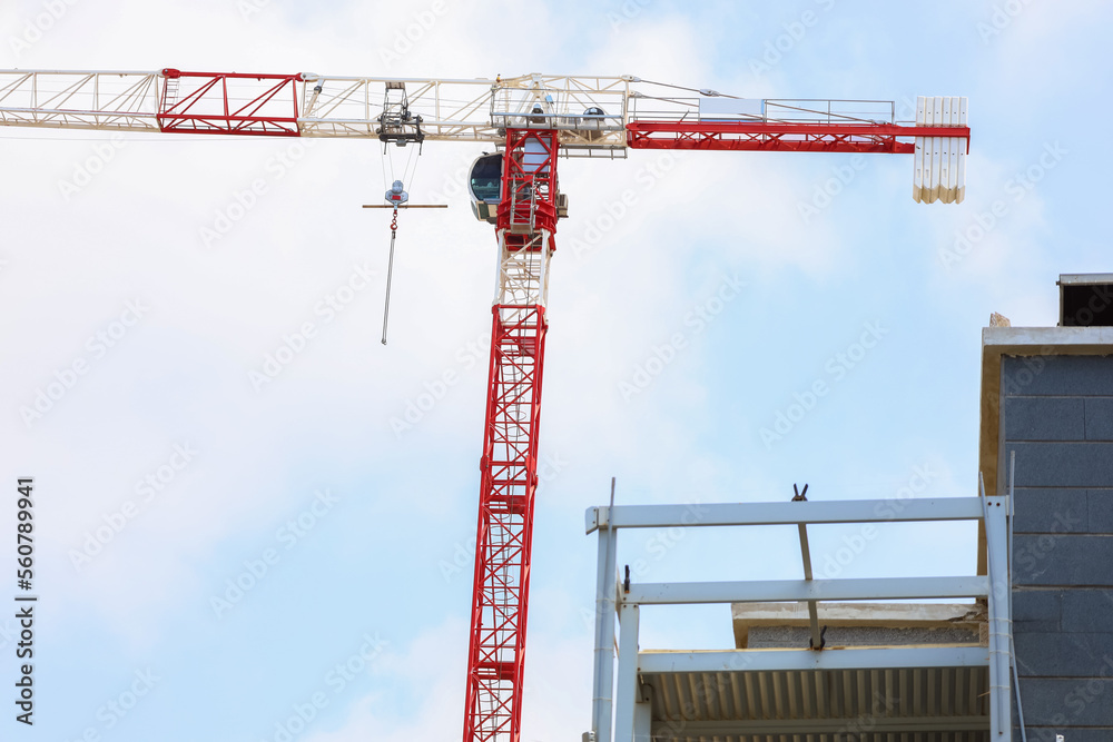 Construction crane near unfinished building