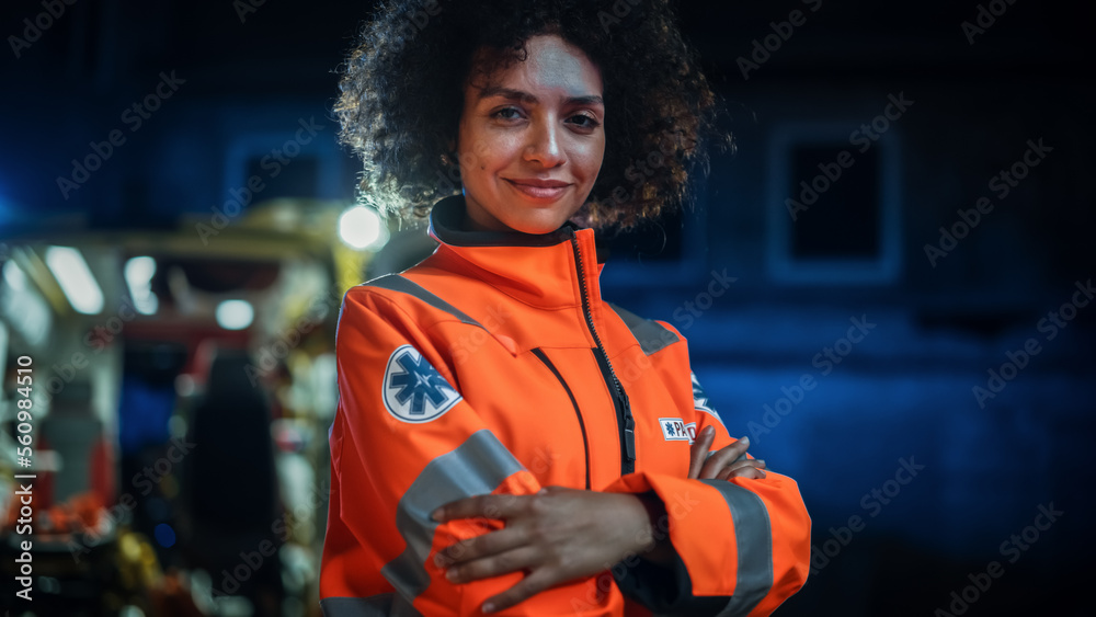 Smiling Female Paramedic Looking at Camera and Posing with Crossed Hands. A Strong Multiethnic Profe