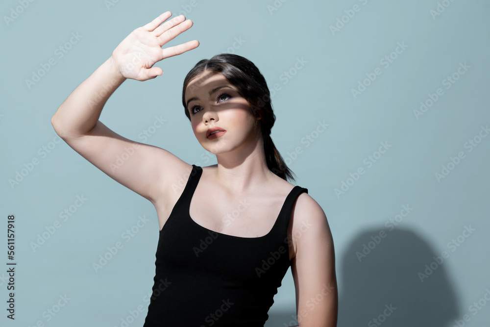 Young charming caucasian teenager girl with clean and fresh skin posing pointing fingers on empty ba
