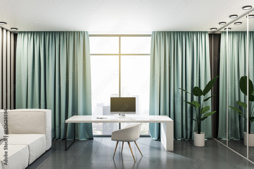 时尚家庭办公室白色工作桌上的现代电脑前视图，配有舒适的浅色沙发，绿色