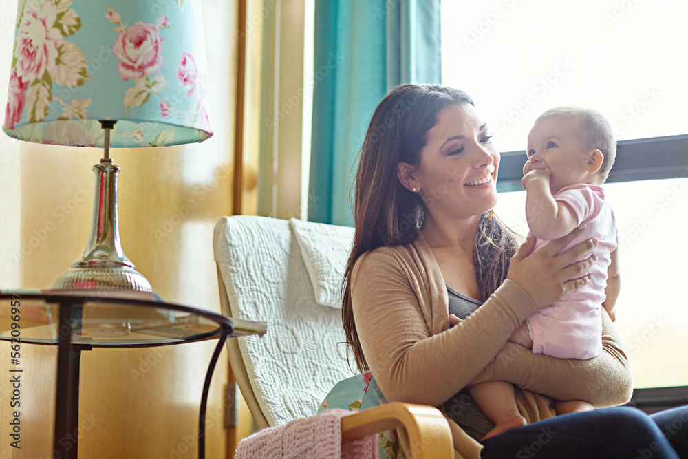 母亲、亲密或顽皮的婴儿坐在婴儿椅上、家庭客厅或桁架中的家庭家具上
