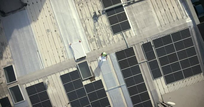 Solar panels, aerial and building man with blueprint for rooftop, architecture or grid design. Drone, solar energy and construction worker, engineering or project management for future city planning