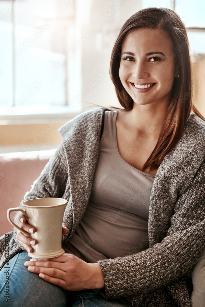 Smile, woman and coffee portrait at home on a living room sofa feeling calm and relax. House, tea an