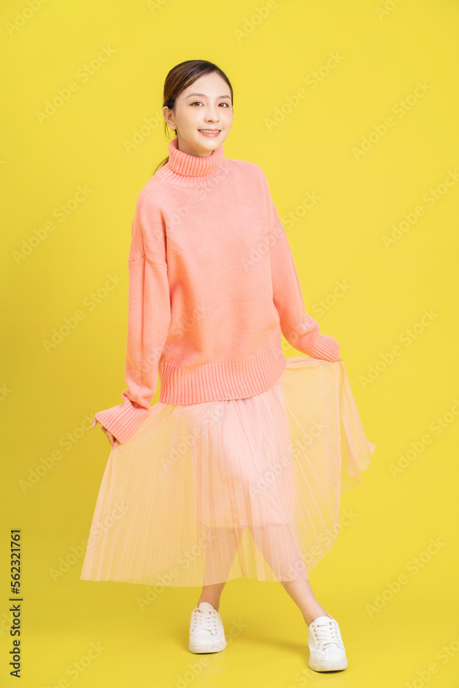Photo of young Asian girl on yellow background