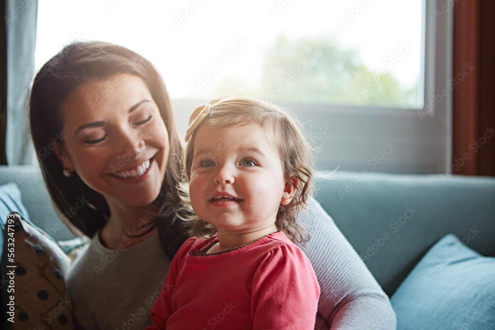 与坐在沙发上的母亲和婴儿一起放松、快乐和微笑，享受亲密、优质的时间和孩子的发展。