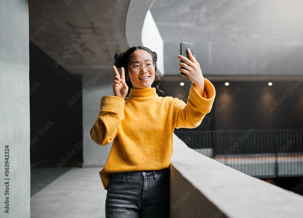 Woman, peace and selfie in office building, smile and happy while on internet, pose and emoji. Asian