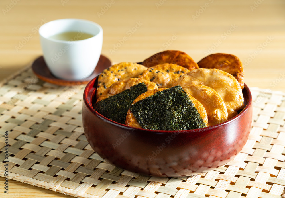 Sembei and green tea on the table. Sembei is a Japanese snack.