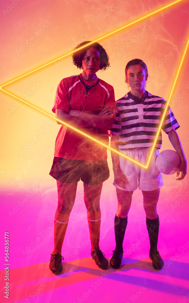 Illuminated triangle over multiracial female rugby players standing over abstract background