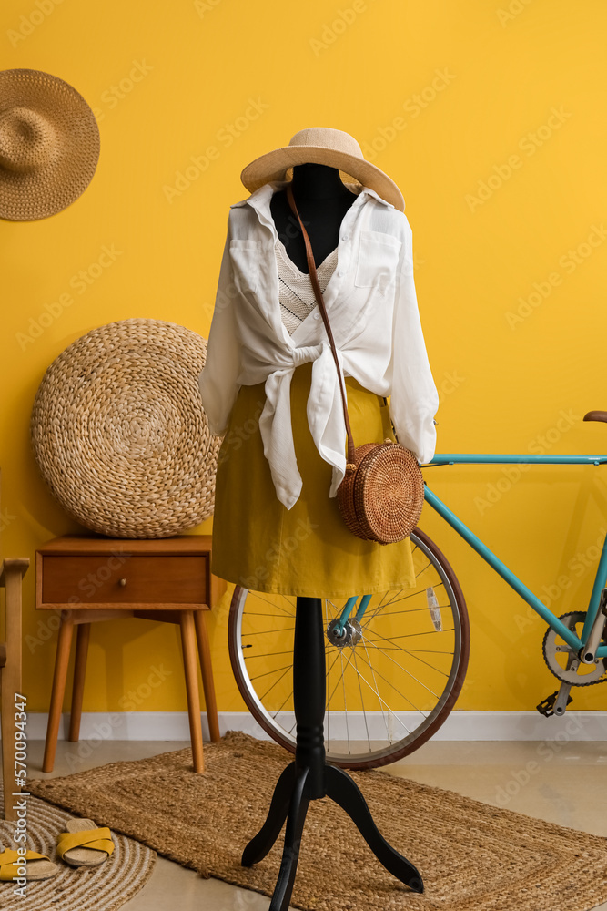 Interior of fashion designers studio with mannequin, clothes and bicycle