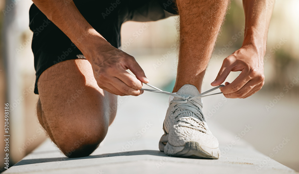 Fitness, shoes and laces with a man runner getting ready for a cardio or endurance workout closeup o