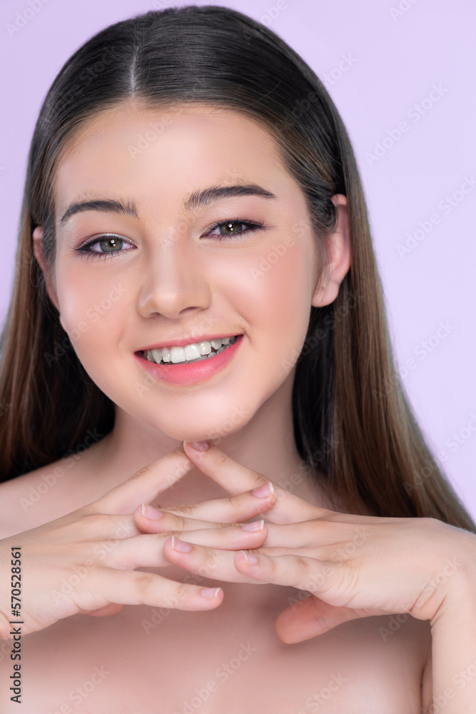 Portrait of young brunette with long hair and flawless skin with hand gesture for beauty and cosmeti
