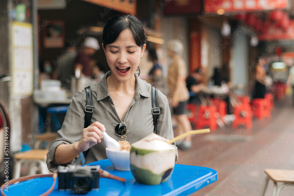 Happy young Asian woman backpack traveler enjoying street food at China town street food market in B