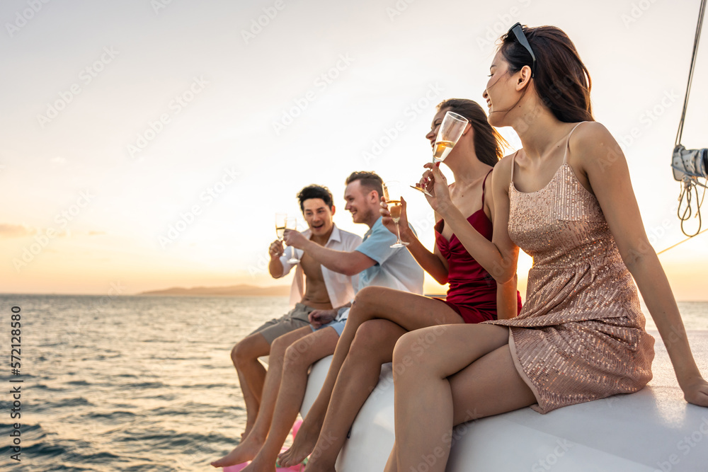 Group of diverse friends drink champagne while having a party in yacht