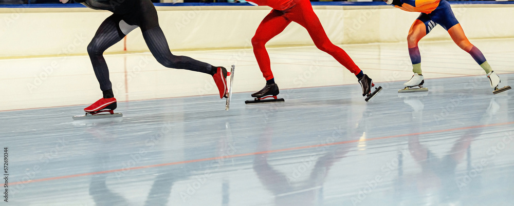 three speed skaters athletes in mass start speed skating