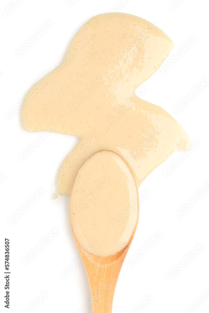 Wooden spoon with tasty tahini on white background, closeup