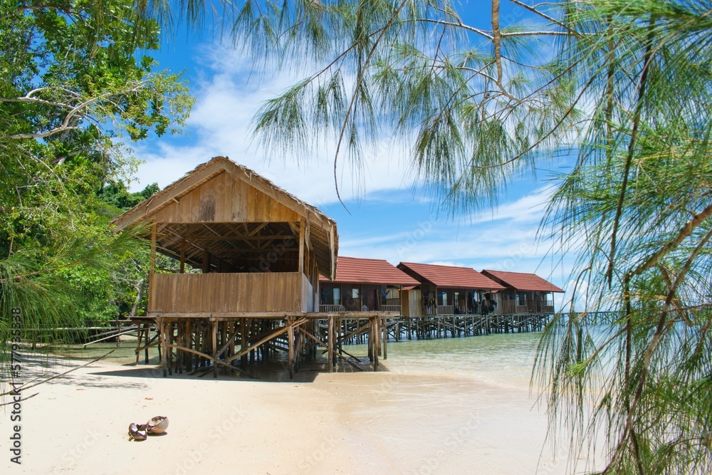 Typical wooden water bungalows on the beach - Waigeo Island, Raja Ampat, West Papua, Indonesia