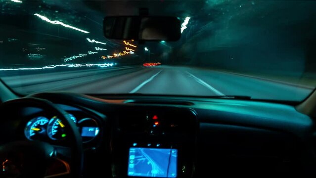 Timelapse car driving on the roads of the night city.