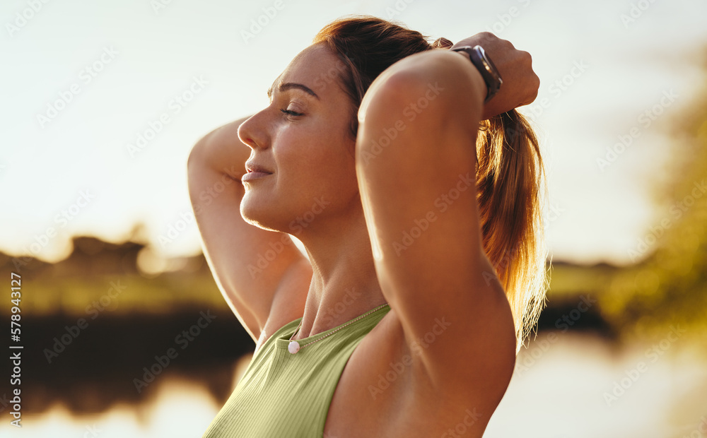 Woman doing a breathing exercise outdoors in the morning