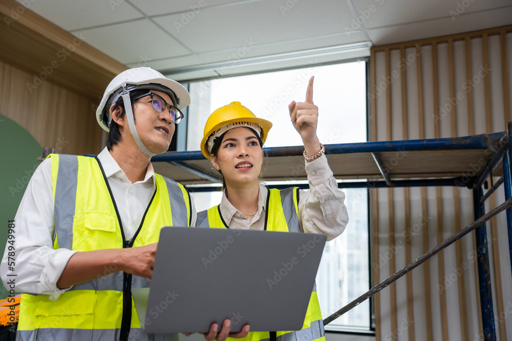 Asian young businessman and businesswoman working in construction site. 