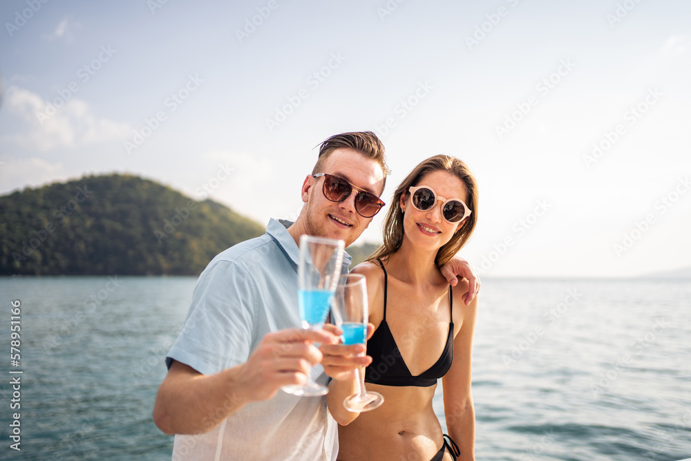 Portrait of Caucasian couple drinking champagne, having party in yacht. 