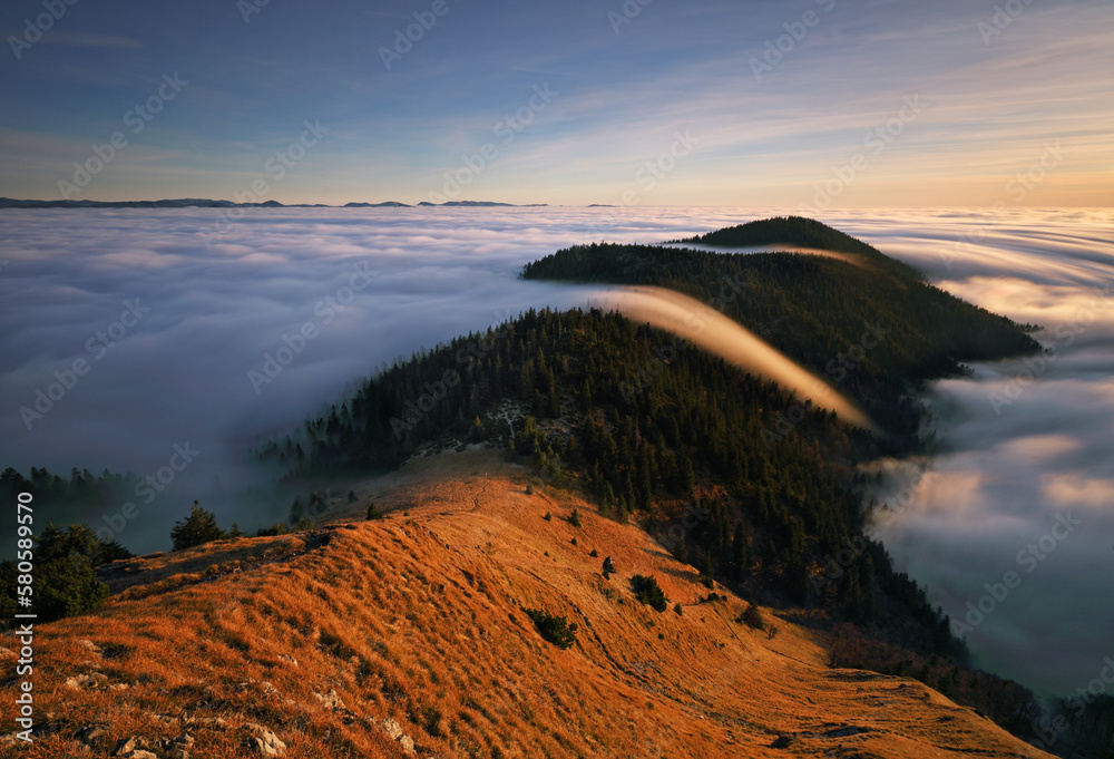 Sunset in the autumn mountains above the clouds during the weather inversion Fatra mountains in Slov