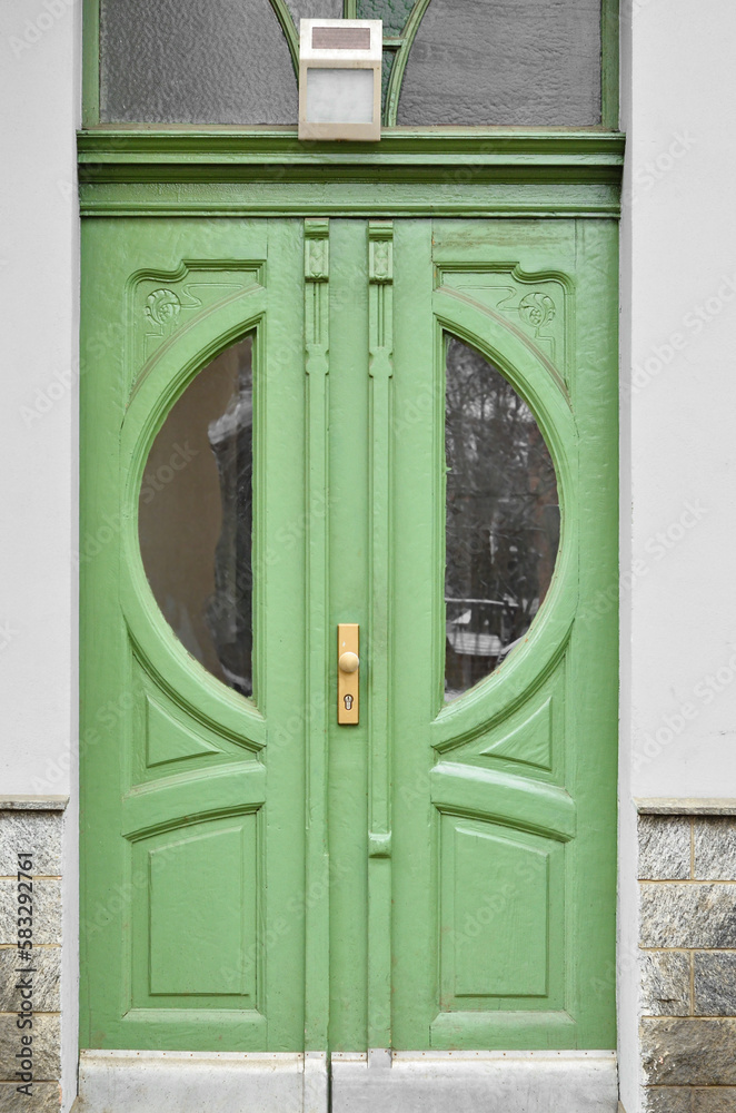 View of old building with green wooden door