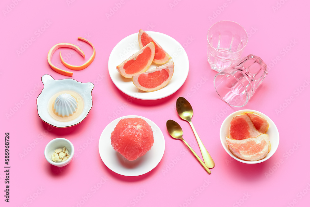 Composition with ripe grapefruits, peel and glasses on pink background