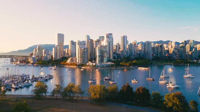 Vancouver downtown skyline aerial reveal shot, BC, Canada at sunset