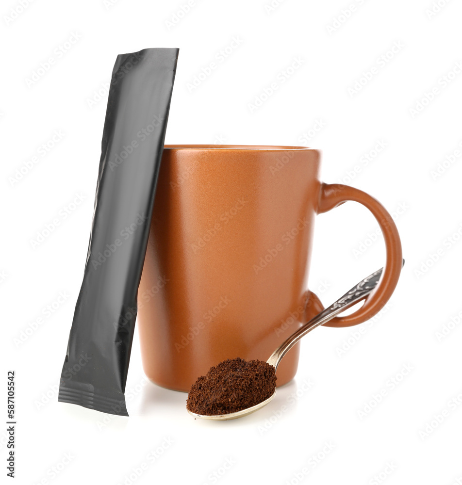Spoon with coffee powder, cup and package isolated on white background
