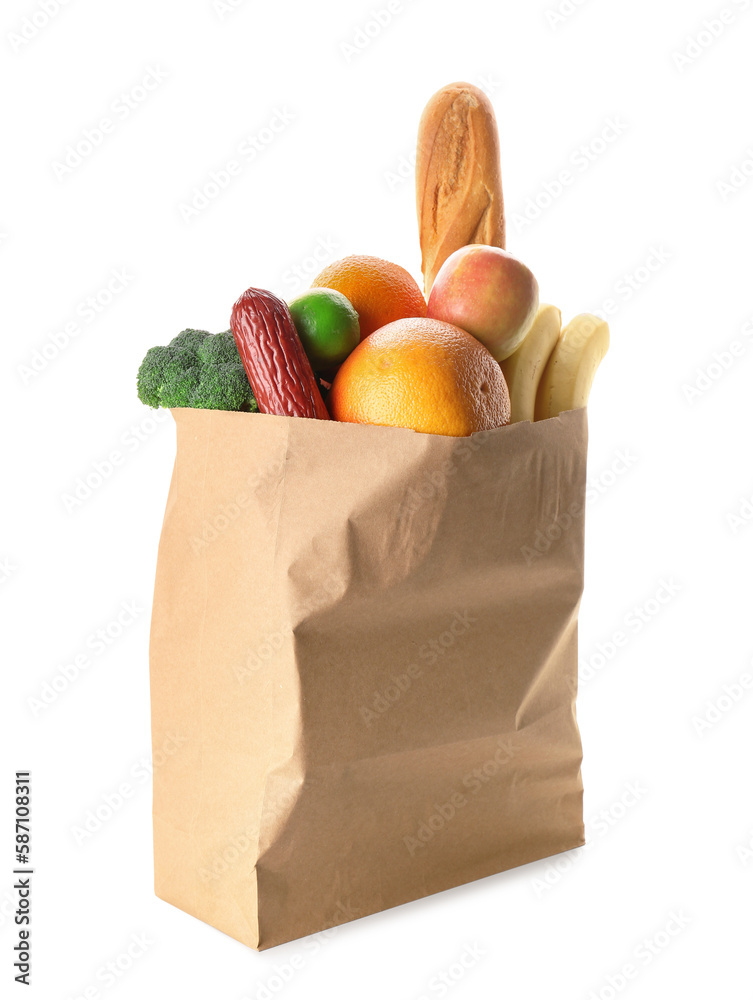 Paper bag with vegetables, fruits and bread on white background