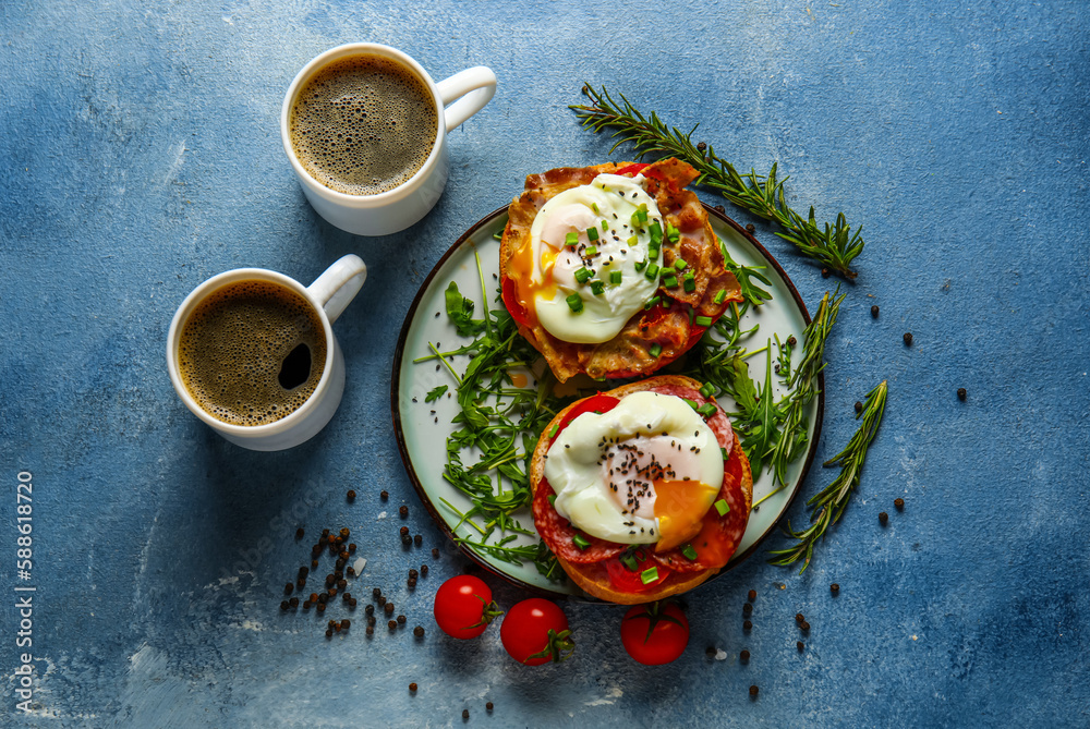 Plate with tasty eggs Benedict and cups of coffee on blue background